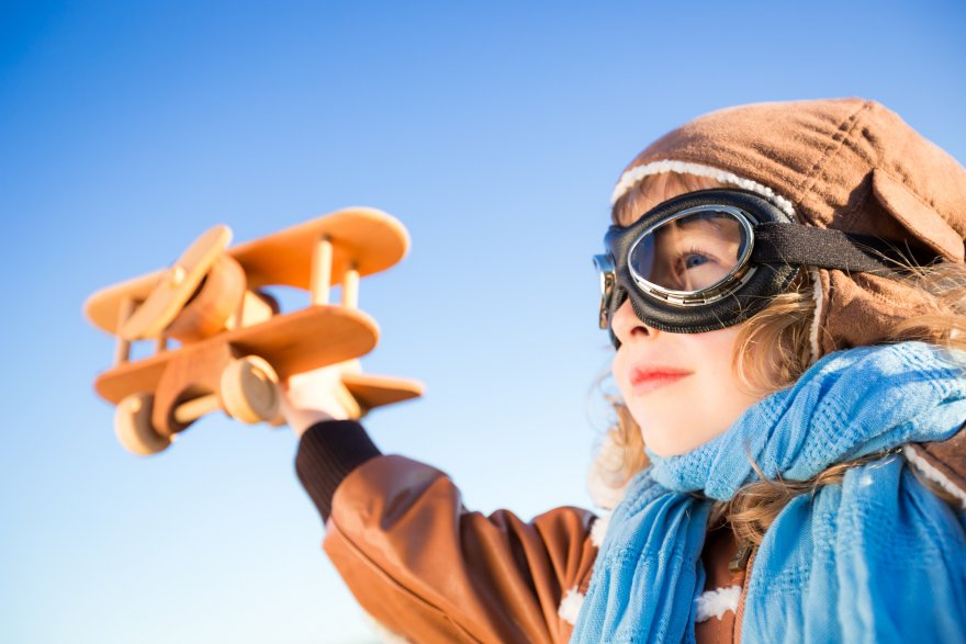 happy-kid-playing-with-toy-airplane-pmdswj6.jpg