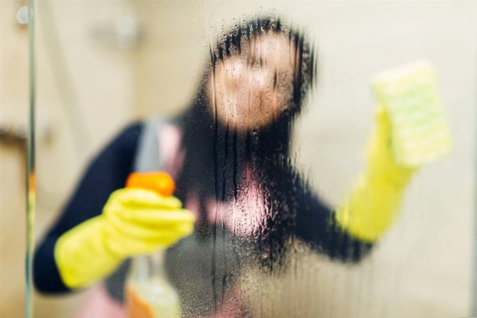 maid-in-gloves-cleans-glass-with-a-cleaning-spray.jpg